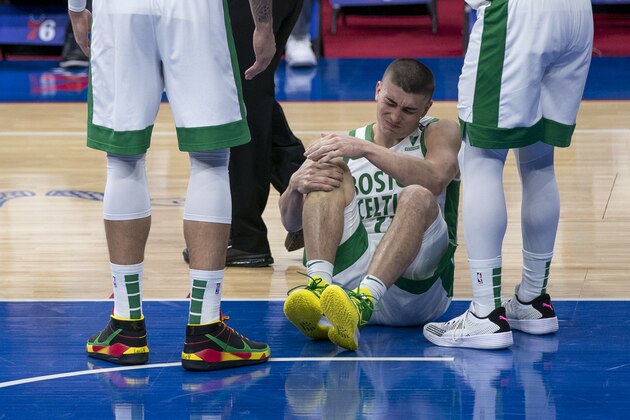 Boston Celtics' Payton Pritchard reacts to getting injured during the first half of an NBA basketball game against the Philadelphia 76ers, Friday, Jan. 22, 2021, in Philadelphia. The 76ers won 122-110. (AP Photo/Chris Szagola)