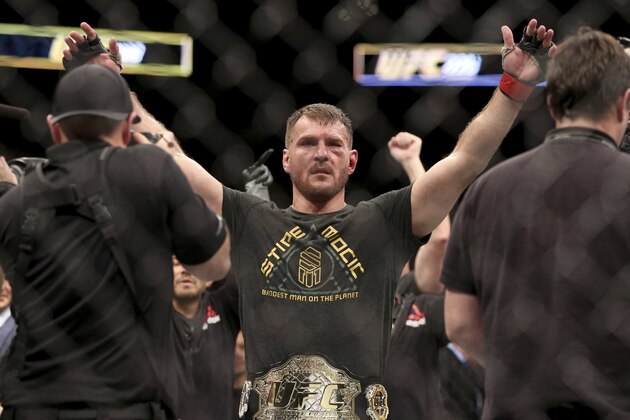 FILE - In this Jan. 21, 2018, file photo, Stipe Miocic gestures after a win over Francis Ngannou during a heavyweight championship mixed martial arts bout at UFC 220, in Boston. Miocic will get the biggest paycheck of his career at UFC 226 for the biggest test of his fighting life against light heavyweight champ Daniel Cormier.(AP Photo/Gregory Payan, File)