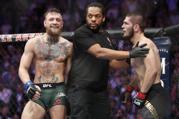 FILE - In this Oct. 6, 2018, file photo, Conor McGregor, left, fights Khabib Nurmagomedov are separated during a UFC 229 mixed martial arts bout in Las Vegas. Nurmagomedov was fined $500,000 and suspended for nine months for a brawl inside and outside the octagon after his fight with Conor McGregor at UFC 229. McGregor was fined $50,000 and suspended for six months.  The suspensions for both fighters are retroactive to Oct. 6. (AP Photo/John Locher, File)