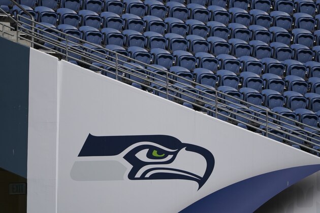 The Seattle Seahawks logo is shown near empty seats at CenturyLink Field during warmups before an NFL football mock game, Wednesday, Aug. 26, 2020, in Seattle. (AP Photo/Ted S. Warren)