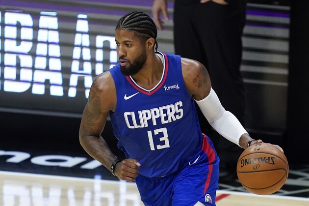 Los Angeles Clippers guard Paul George (13) moves the ball down the court during the first half of an NBA basketball game against the New Orleans Pelicans Wednesday, Jan. 13, 2021, in Los Angeles. (AP Photo/Ashley Landis)