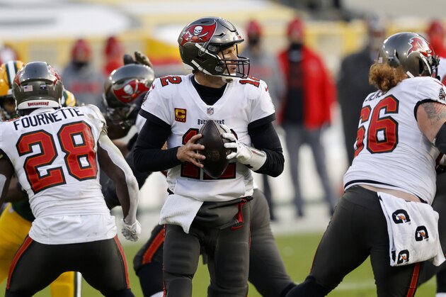 Tampa Bay Buccaneers quarterback Tom Brady (12) looks to pass against the Green Bay Packers during the first half of the NFC championship NFL football game in Green Bay, Wis., Sunday, Jan. 24, 2021. (AP Photo/Jeffrey Phelps)