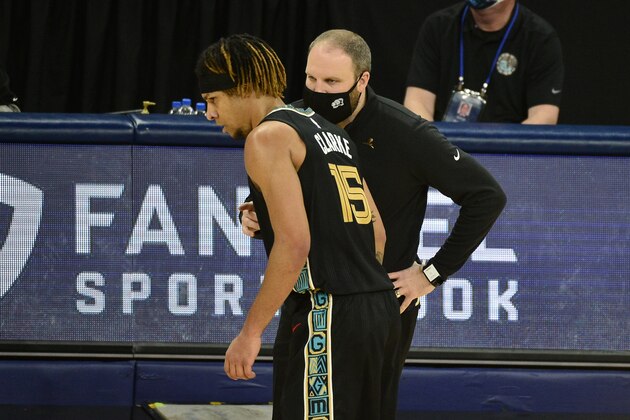 Memphis Grizzlies head coach Taylor Jenkins, front right, talks with forward Brandon Clarke (15) in the first half of an NBA basketball game against the Phoenix Suns, Monday, Jan. 18, 2021, in Memphis, Tenn. (AP Photo/Brandon Dill)