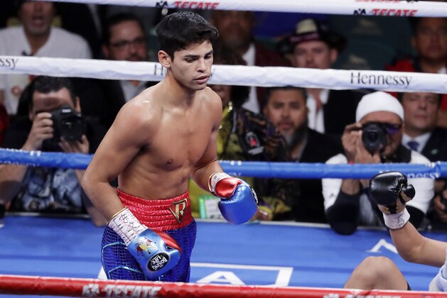 FILE - In this Nov. 2, 2019 file photo, Ryan Garcia, looks on after landing a punch to Romero Duno (not seen) during their lightweight boxing match in Las Vegas.   Garcia meets Britainâ€™s Luke Campbell, a 2012 Olympic champion, in an interim WBC lightweight title fight. The bout was postponed a month and moved from California after Campbell tested positive for COVID-19.(AP Photo/Isaac Brekken, File)