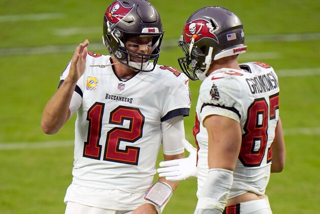 Tampa Bay Buccaneers quarterback Tom Brady (12) celebrates with teammate tight end Rob Gronkowski (87) after scoring a touchdown against the Las Vegas Raiders during the second half of an NFL football game, Sunday, Oct. 25, 2020, in Las Vegas. (AP Photo/Jeff Bottari)