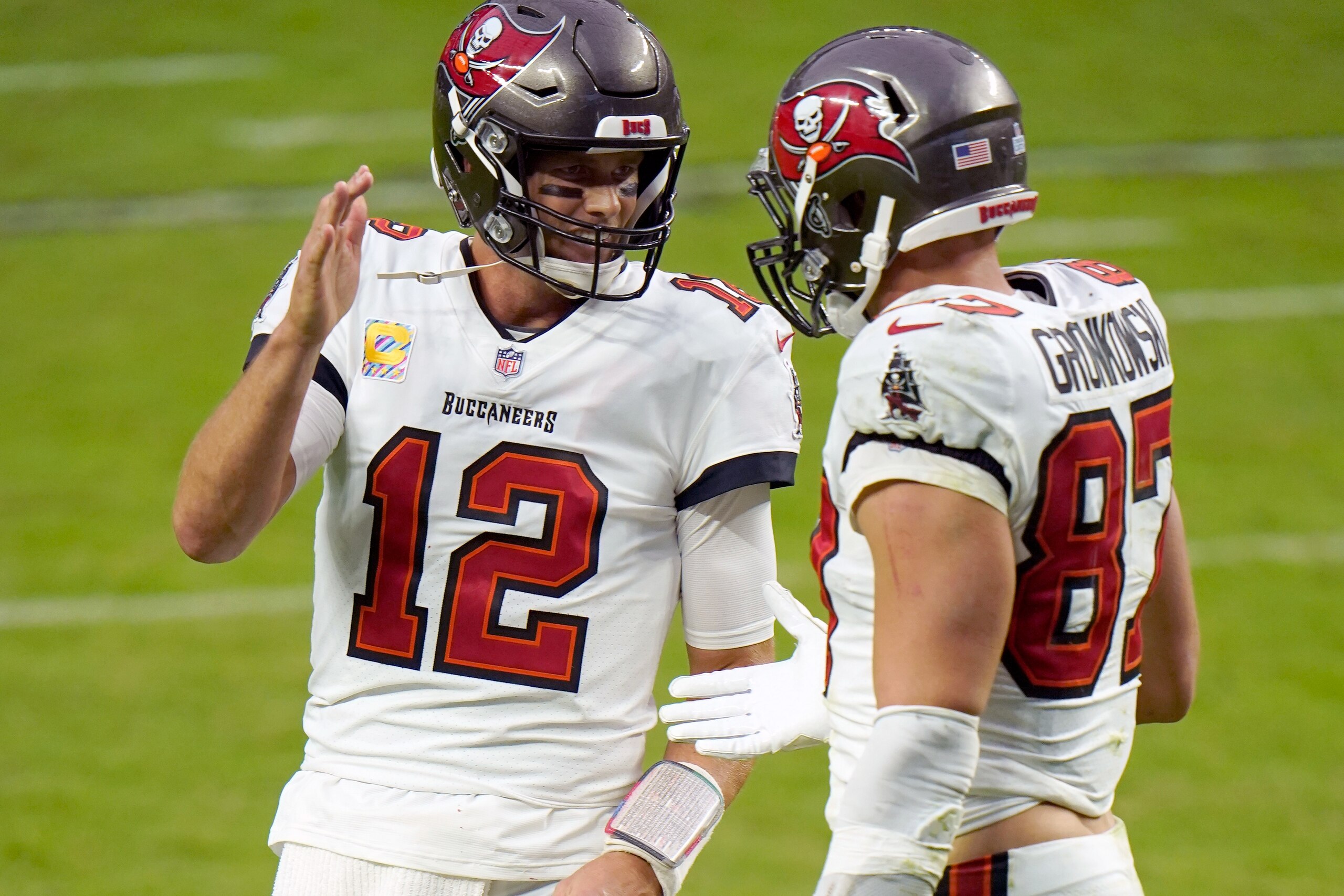 Tampa Bay Buccaneers quarterback Tom Brady (12) celebrates with teammate tight end Rob Gronkowski (87) after scoring a touchdown against the Las Vegas Raiders during the second half of an NFL football game, Sunday, Oct. 25, 2020, in Las Vegas. (AP Photo/Jeff Bottari)