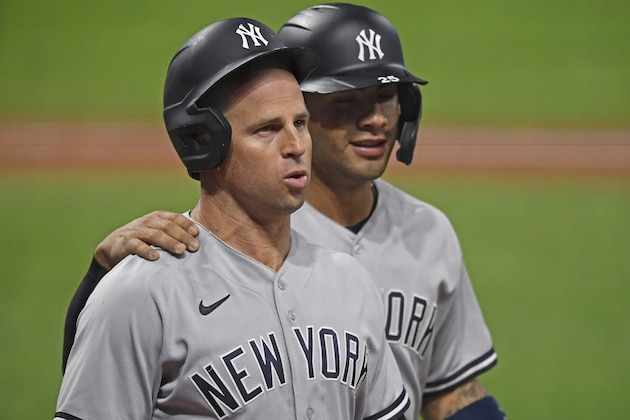 New York Yankees' Brett Gardner (11) walls to the dugout with Gleyber Torres after hitting a two run home run in the seventh inning of Game 1 of an American League wild-card baseball series against the Cleveland Indians, Tuesday, Sept. 29, 2020, in Cleveland. (AP Photo/David Dermer)