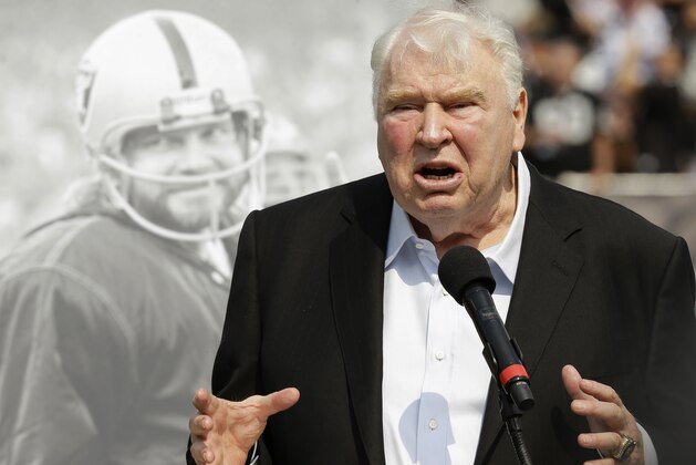 FILE - In this Sept. 13, 2015, file photo, former Oakland Raiders head coach John Madden speaks about former quarterback Ken Stabler, pictured at rear, at a ceremony honoring Stabler during halftime of an NFL football game between the Raiders and the Cincinnati Bengals in Oakland, Calif. Pro Football Hall of Fame coaches John Madden and Marv Levy are among the presenters chosen to welcome the eight-person Class of 2016 at the induction ceremonies on Aug. 6 in Canton, Ohio. Madden will speak on behalf of the late quarterback Ken Stabler, who played for Madden with the Oakland Raiders in the 1970s. The quarterback died in 2015 at the age of 69.  (AP Photo/Ben Margot, File)