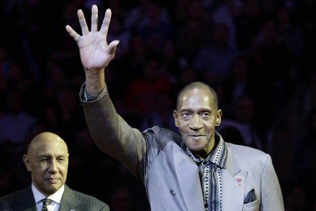 Harthorne Wingo waves to the crowd as teammate Henry Bibby, left, claps during a ceremony to honor the 1972-73 world champion New York Knicks team during an NBA basketball game between the Knicks and the Milwaukee Bucks, Friday, April 5, 2013, in New York. (AP Photo/Frank Franklin II)