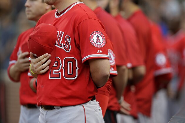Los Angeles Angels' C.J. Cron (20) holds his hat over his heart during a rendition of the national anthem before a baseball game against the Baltimore Orioles, Wednesday, July 30, 2014, in Baltimore. (AP Photo/Patrick Semansky)