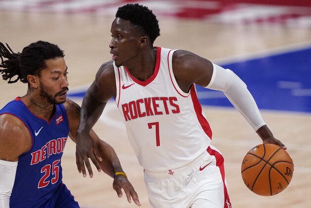 Houston Rockets guard Victor Oladipo (7) drives on Detroit Pistons guard Derrick Rose (25) during the second half of an NBA basketball game, Friday, Jan. 22, 2021, in Detroit. (AP Photo/Carlos Osorio)