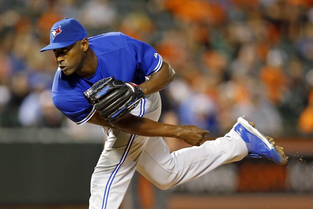 Toronto Blue Jays relief pitcher LaTroy Hawkins follows through on a pitch to the Baltimore Orioles in the ninth inning in the first baseball game of a doubleheader, Wednesday, Sept. 30, 2015, in Baltimore. (AP Photo/Patrick Semansky)