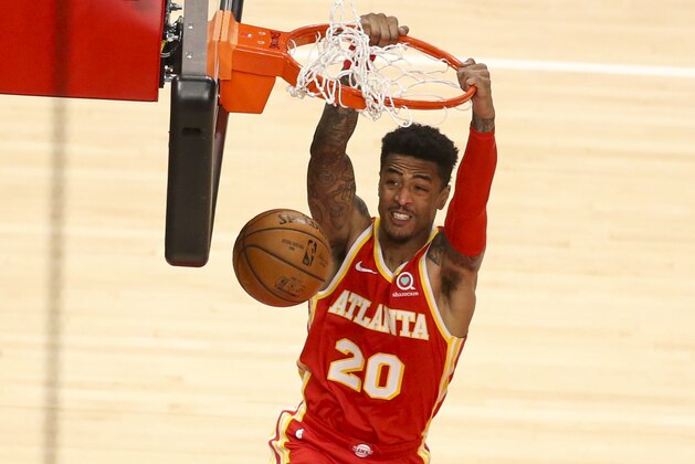 Atlanta Hawks forward John Collins (20) dunks in the second half of an NBA basketball game against the Detroit Pistons, Monday, Dec. 28, 2020, in Atlanta. The Hawks won 128-120. (AP Photo/Brett Davis)