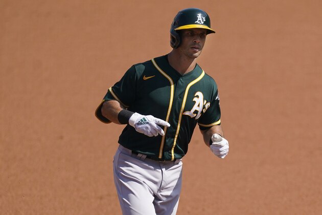 Oakland Athletics' Tommy La Stella rounds the bases after hitting a solo home run against the Houston Astros during the first inning of Game 3 of a baseball American League Division Series in Los Angeles, Wednesday, Oct. 7, 2020. (AP Photo/Ashley Landis)