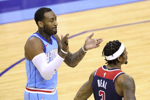 Houston Rockets' John Wall applauds a call, next to Washington Wizards' Bradley Beal during the fourth quarter of an NBA basketball game Tuesday, Jan. 26, 2021, in Houston. (Carmen Mandato/Pool Photo via AP)