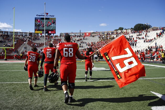 Maryland offensive lineman Ellis McKennie waves a flag in remembrance of teammate Jordan McNair, who died after collapsing on a practice field during a spring practice, after an NCAA college football game against Rutgers, Saturday, Oct. 13, 2018, in College Park, Md. Maryland won 34-7. (AP Photo/Patrick Semansky)