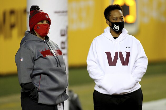 Tampa Bay Buccaneers defensive line coach Lori Locust and Washington Football Team coaching intern Jennifer King in action before an NFL wild-card playoff football game against the Tampa Bay Buccaneers, Saturday, Jan. 9, 2021 in Landover, Md. (AP Photo/Daniel Kucin Jr.)