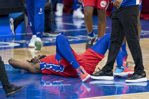 Philadelphia 76ers' Joel Embiid lays on the court during the second half of an NBA basketball game against the Boston Celtics, Friday, Jan. 22, 2021, in Philadelphia. The 76ers won 122-110. (AP Photo/Chris Szagola)