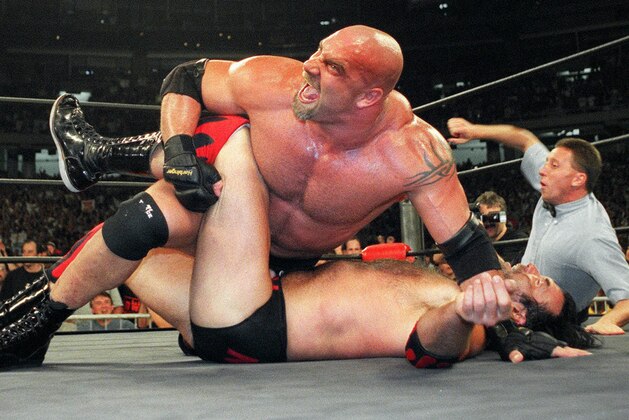 FILE - In this July 6, 1998, file photo, World Championship Wrestling heavyweight champion Bill Goldberg puts Scott Hall to the mat during a match in Atlanta. Bill Goldberg found his toughest tag-team partner yet.