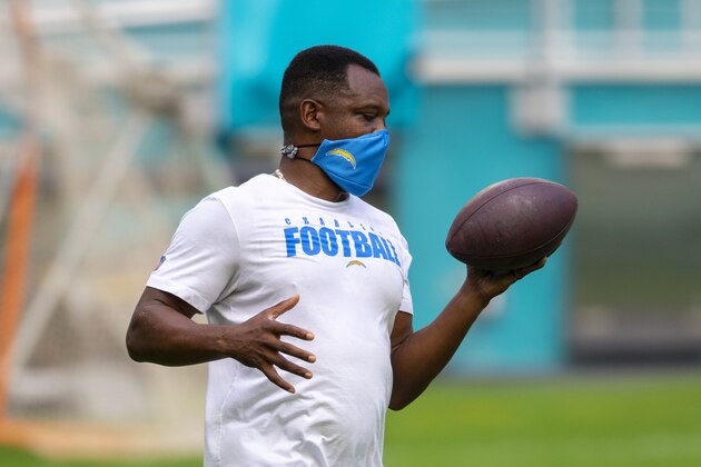 Los Angeles Chargers quarterbacks coach Pep Hamilton holds a football on the field before the Los Angeles Chargers take on the Miami Dolphins during an NFL football game, Sunday, Nov. 15, 2020, in Miami Gardens, Fla. (AP Photo/Doug Murray)