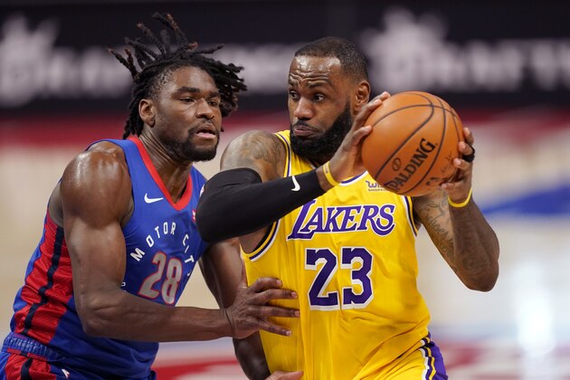 Los Angeles Lakers forward LeBron James (23) drives as Detroit Pistons center Isaiah Stewart (28) defends during the first half of an NBA basketball game, Thursday, Jan. 28, 2021, in Detroit. (AP Photo/Carlos Osorio)