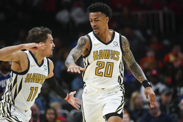 Atlanta Hawks forward John Collins (20) and guard Trae Young celebrate a point during an NBA basketball game against the Philadelphia 76ers, Saturday, March 23, 2019, in Atlanta. (AP Photo/John Amis)