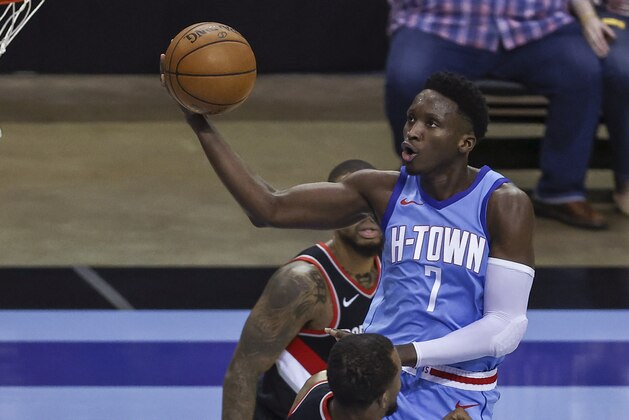 Houston Rockets guard Victor Oladipo (7) drives to the basket over Portland Trail Blazers' Rodney Hood during the third quarter of an NBA basketball game Thursday, Jan. 28, 2021, in Houston. (Troy Taormina/Pool Photo via AP)