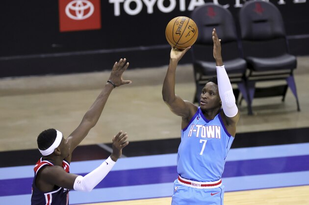 Houston Rockets' Victor Oladipo shoot over Washington Wizards' Isaac Bonga during the third quarter of an NBA basketball game Tuesday, Jan. 26, 2021, in Houston. (Carmen Mandato/Pool Photo via AP)