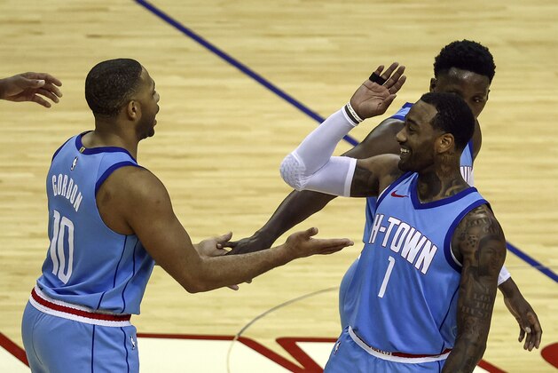 Houston Rockets guard Eric Gordon (10) and guard John Wall (1) celebrate after a play during the fourth quarter of an NBA basketball game against the Portland Trail Blazers, Thursday, Jan. 28, 2021, in Houston. (Troy Taormina/Pool Photo via AP)