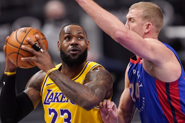Los Angeles Lakers forward LeBron James (23) looks to shoot as Detroit Pistons center Mason Plumlee (24) defends during the first half of an NBA basketball game, Thursday, Jan. 28, 2021, in Detroit. (AP Photo/Carlos Osorio)