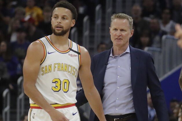 Golden State Warriors guard Stephen Curry (30) talks with head coach Steve Kerr against the Toronto Raptors during an NBA basketball game in San Francisco, Thursday, March 5, 2020. (AP Photo/Jeff Chiu)