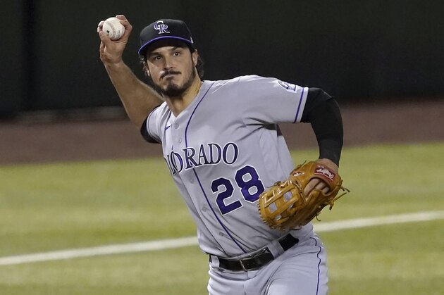 Colorado Rockies Nolan Arenado (28) throws to first against the Arizona Diamondbacks during the eighth inning of a baseball game, Tuesday, Aug. 25, 2020, in Phoenix. (AP Photo/Matt York)