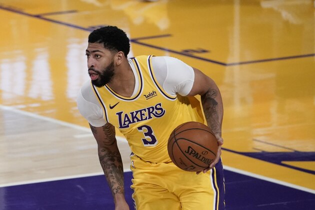 Los Angeles Lakers' Anthony Davis dribbles the ball during the first half of an NBA basketball game against the Golden State Warriors, Monday, Jan. 18, 2021, in Los Angeles. (AP Photo/Jae C. Hong)