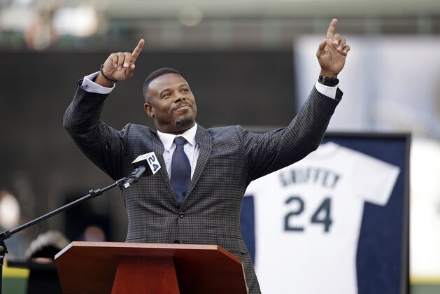 FILE - In this Aug. 7, 2016, file photo, former Seattle Mariners outfielder Ken Griffey Jr. raises his arms as he is introduced to speak during a ceremony honoring him for his induction into the Hall of Fame, before a baseball game between the Mariners and the Los Angeles Angels in Seattle. Griffey's induction into the Hall of Fame was among the top news stories in Washington state in 2016. (AP Photo/Elaine Thompson, File)