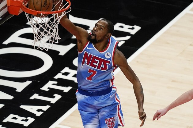 Brooklyn Nets forward Kevin Durant scores in overtime of the team's NBA basketball game against the Atlanta Hawks on Wednesday, Jan. 27, 2021, in Atlanta. (AP Photo/Brynn Anderson)