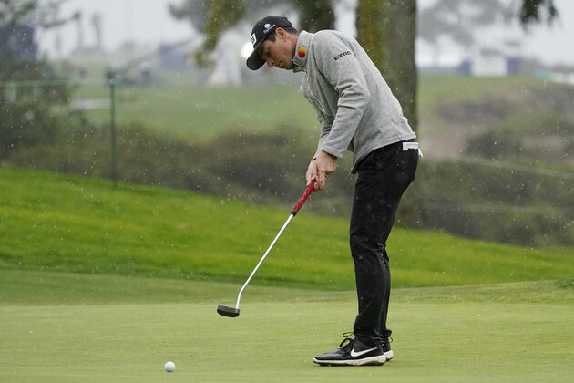 Viktor Hovland, left, of Norway, putts on the eighth hole of the South Course during the second round of the Farmers Insurance Open golf tournament at Torrey Pines, Friday, Jan. 29, 2021, in San Diego. (AP Photo/Gregory Bull)