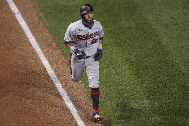 Minnesota Twins' Eddie Rosario rounds the bases after hitting a solo home run off Chicago Cubs starting pitcher Alec Mills during the first inning of a baseball game, Saturday, Sept. 19, 2020, in Chicago. (AP Photo/Kamil Krzaczynski)
