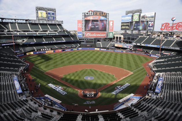 FILE - In this Oct. 29, 2015, file photo, members of the media and grounds crew work on the field at Citi Field in New York, the day before Game 3 of the World Series between the Mets and the Kansas City Royals at the stadium. Baseball Commissioner Rob Manfred says talks have ended over the proposed sale of a controlling share of the Mets from the families of Fred Wilpon and Saul Katz to hedge fund manager Steven Cohen. (AP Photo/Peter Morgan, File)