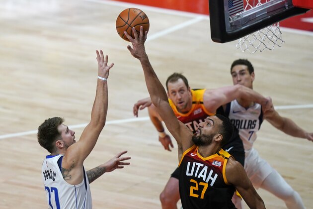 Utah Jazz center Rudy Gobert (27) blocks the shot from Dallas Mavericks guard Luka Doncic (77) during the second half of an NBA basketball game Friday, Jan. 29, 2021, in Salt Lake City. (AP Photo/Rick Bowmer)