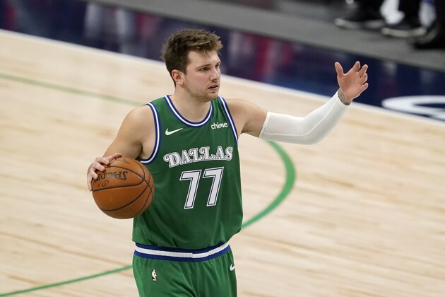 Dallas Mavericks guard Luka Doncic (77) advances the ball up court against the Houston Rockets during an NBA basketball game in Dallas, Saturday, Jan. 23, 2021. (AP Photo/Tony Gutierrez)