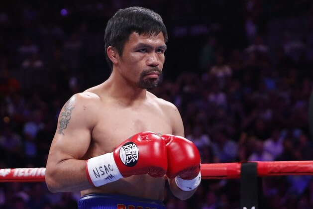 FILE - In this Saturday, July 20, 2019 file photo, Manny Pacquiao prepares to fight Keith Thurman in a welterweight title fight in Las Vegas. Qatar is preparing to host the 2022 World Cup and is now looking to attract big-name boxing. Promoter Bob Arum has been in talks with Qatari officials about bringing a welterweight unification bout between Manny Pacquiao and Terence Crawford to the energy-rich Gulf nation. (AP Photo/John Locher, File)