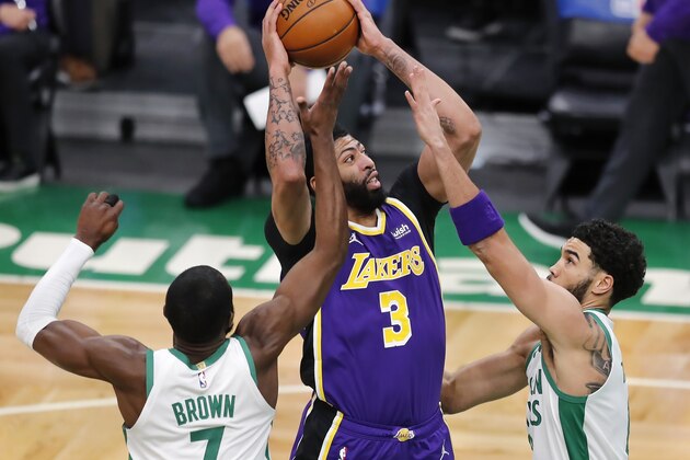 Los Angeles Lakers' Anthony Davis (3) shoots between Boston Celtics' Jaylen Brown (7) and Jayson Tatum during the first half of an NBA basketball game Saturday, Jan. 30, 2021, in Boston. (AP Photo/Michael Dwyer)
