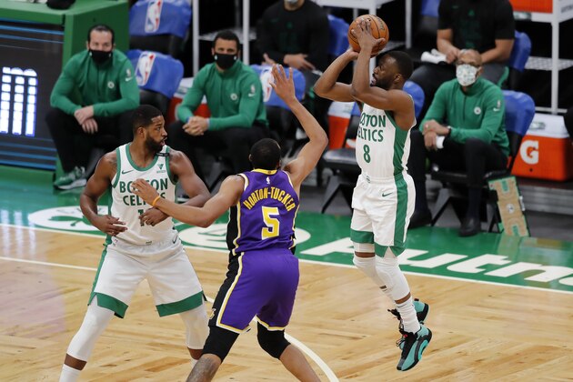 Boston Celtics' Kemba Walker (8) shoots against Los Angeles Lakers' Talen Horton-Tucker (5) during the first half of an NBA basketball game, Saturday, Jan. 30, 2021, in Boston. (AP Photo/Michael Dwyer)