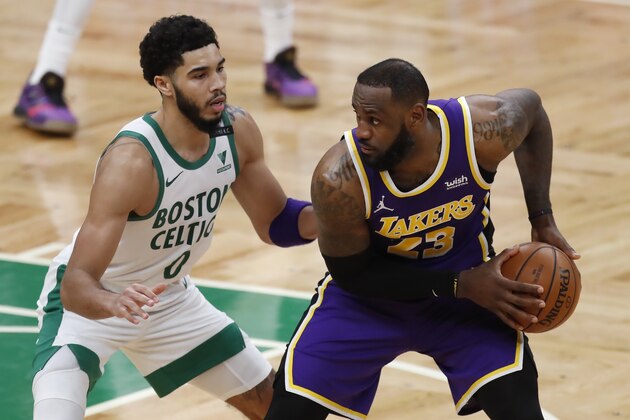 Boston Celtics' Jayson Tatum (0) defends against Los Angeles Lakers' LeBron James (23) during the second half of an NBA basketball game Saturday, Jan. 30, 2021, in Boston. (AP Photo/Michael Dwyer)