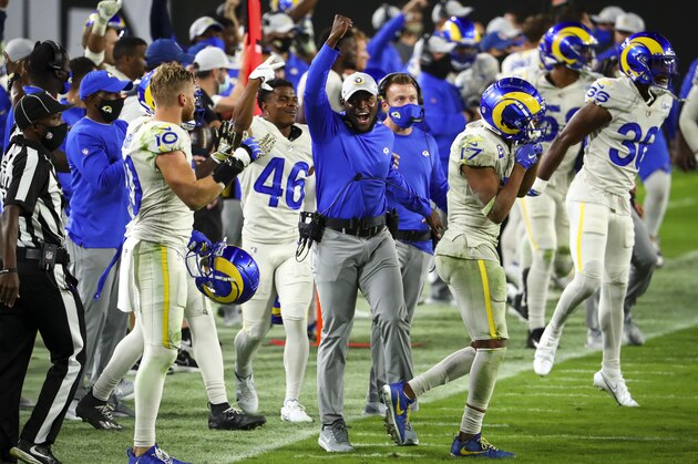 Los Angeles Rams safeties coach Ejiro Evero celebrates after an interception in the final minutes of an NFL Football game against the Tampa Bay Buccaneers, Monday, Nov. 23, 2020, in Tampa, Fla. (AP Photo/Kevin Sabitus)
