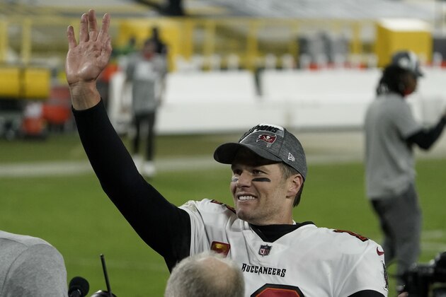 Tampa Bay Buccaneers quarterback Tom Brady waves to spectators after winning the NFC championship NFL football game against the Green Bay Packers in Green Bay, Wis., Sunday, Jan. 24, 2021. The Buccaneers defeated the Packers 31-26 to advance to the Super Bowl. (AP Photo/Morry Gash)