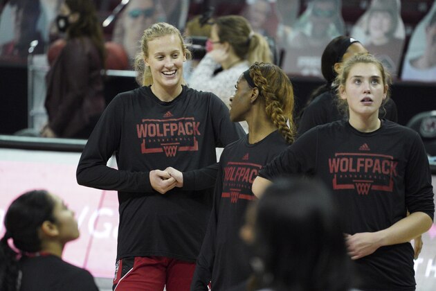North Carolina State center Elissa Cunane, left, warms up with teammates before an NCAA college basketball game against South Carolina Thursday, Dec. 3, 2020, in Columbia, S.C. North Carolina State won 54-46. (AP Photo/Sean Rayford)