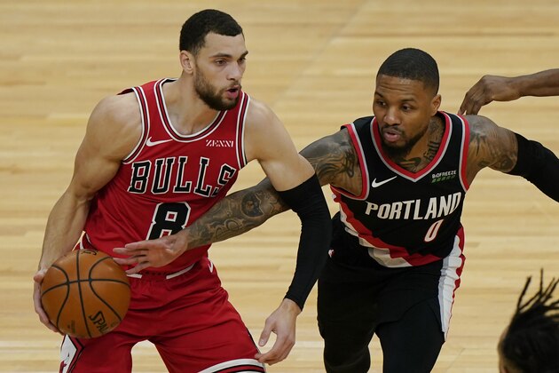 Chicago Bulls guard Zach LaVine, left, looks to pass as Portland Trail Blazers guard Damian Lillard tries to steal the ball during the first half of an NBA basketball game in Chicago, Saturday, Jan. 30, 2021. (AP Photo/Nam Y. Huh)
