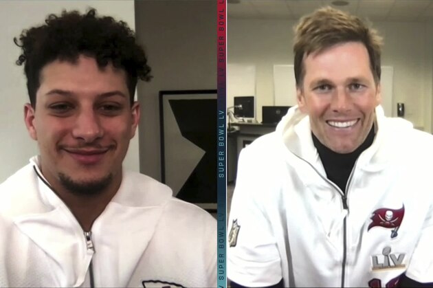 In this still image from video provided by the NFL, Kansas City Chiefs quarterback Patrick Mahomes, left, and Tampa Bay Buccaneers quarterback Tom Brady speak during Opening Night for the NFL Super Bowl 55 football game Monday, Feb. 1, 2021. (NFL via AP)