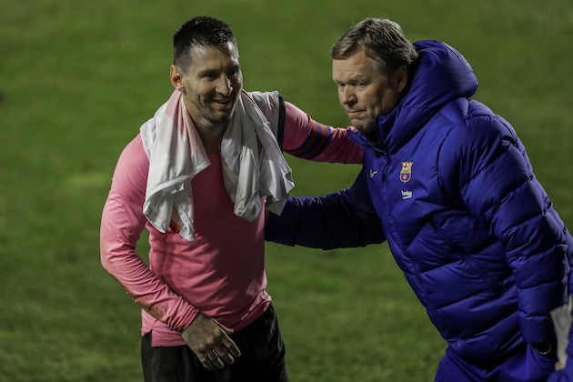 Barcelona's Lionel Messi, left, and Barcelona's head coach Ronald Koeman celebrate after winning a Spanish Copa del Rey round of 16 soccer match against Rayo Vallecano at the Vallecas stadium in Madrid, Spain, Wednesday, Jan. 27, 2021. (AP Photo/Manu Fernandez)